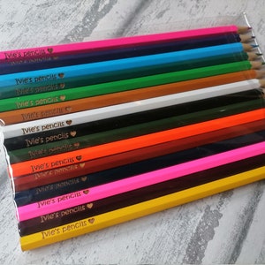 May include: A set of 14 colourful pencils with the words "Ivie's pencils" and a heart symbol engraved on each pencil.