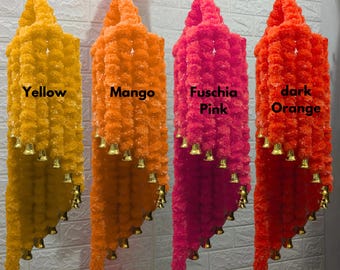 May include: Four strands of artificial flower garlands with bells hanging from them. The garlands are yellow, orange, pink, and dark orange. The text below each garland reads "Yellow", "Mango", "Fuschia Pink", and "dark Orange".