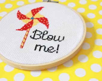May include: A white embroidery hoop with a red and yellow pinwheel and the text "Blow me!" on a yellow background with white polka dots.