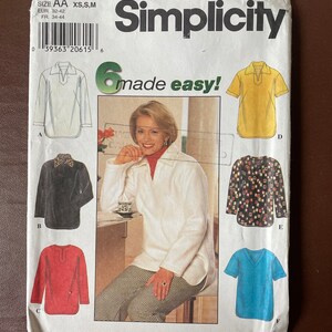 May include: Simplicity sewing pattern 7704, size AA XS, S, M, EUR 32-42, FR 34-44. The pattern includes six different styles of tops, including a collared shirt, a V-neck shirt, and a short-sleeved shirt. The pattern is labelled "made easy!" and features a woman wearing one of the tops.