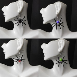 May include: Four pairs of black beaded spider earrings with different colored beads. The beads are black, purple, red, and green.