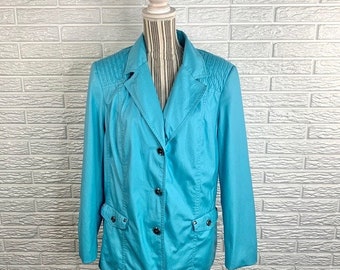 May include: A turquoise blue blazer with a button front closure and two pockets. The blazer has a quilted design on the shoulders and a slightly fitted silhouette.