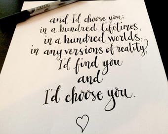May include: Handwritten quote on a white background: "and I'd choose you in a hundred lifetimes, in a hundred worlds, in any versions of reality, I'd find you and I'd choose you." A small heart is drawn below the text.
