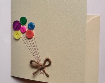 Handmade Birthday Card: pearlescent peach coloured card with colourful balloon buttons