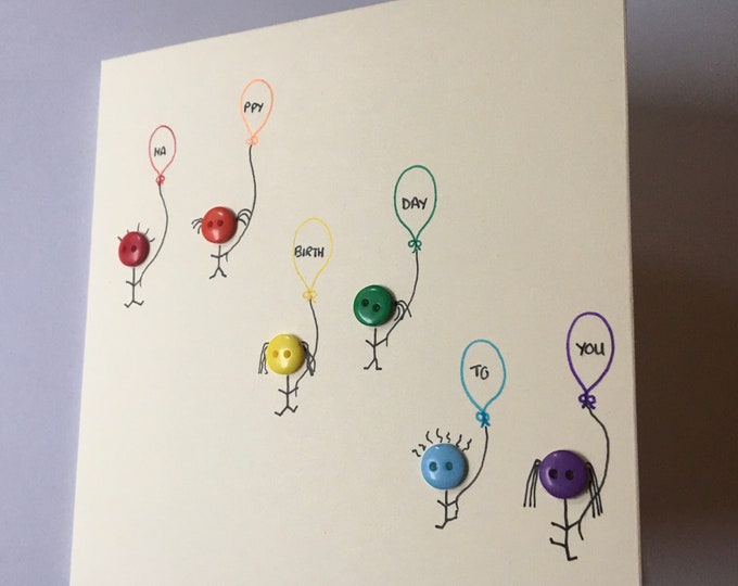 Birthday card with "happy birthday" balloons held by my rainbow button little people. Hand made. On brown or cream card
