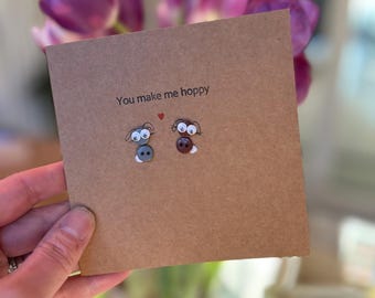 You make me hoppy.  handmade with buttons. love/friendship cards with button bunnies. On kraft brown or cream  card. Sold individually.
