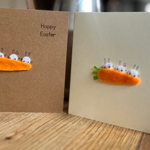 My Easter bunnies hiding behind a carrot! On kraft brown or cream  card. Easter greeting cards . Sold individually.