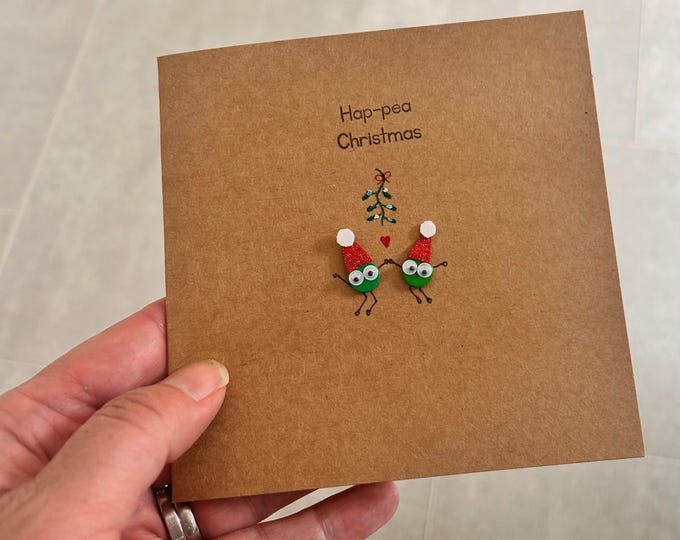 Under  the mistletoe. Festive pea card