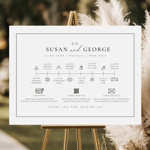 May include: A white ceramic mug with a black handle and the text "But First, Coffee" in a bold, black font. The mug is filled with a dark liquid, likely coffee, and sits on a light-colored surface.