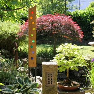 Garden sculpture made of wood and glass. Garden decorations are unique, handmade and weatherproof.