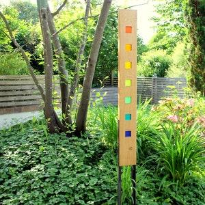 Garden sculpture made of wood and glass. A unique, handmade, and weatherproof garden decoration.