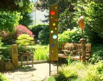 Garden sculpture made of wood and glass. Garden decorations are unique, handmade and weatherproof.