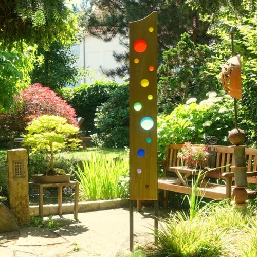 Garden sculpture made of wood and glass. A unique, handmade, and weatherproof garden decoration.