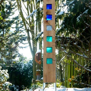 Garden sculpture made of wood and glass. A unique, handmade, and weatherproof garden decoration.