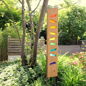 Garden sculpture made of wood and glass. A unique, handmade, and weatherproof garden decoration.