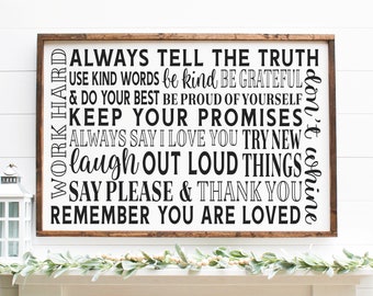 May include: A framed wooden sign with a white background and black text. The sign features inspirational phrases like "Always Tell The Truth" and "Remember You Are Loved". The frame is a dark brown color.
