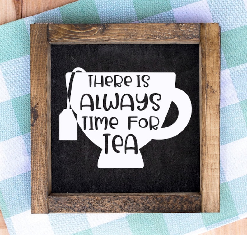 May include: A framed wooden sign with the text "THERE IS ALWAYS TIME FOR TEA" in white, set against a black background. The text is designed within the shape of a teacup with a tea bag attached. The frame is made of dark brown wood.