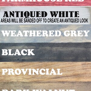May include: A color chart featuring wooden planks with paint swatches. The colors are labeled: Farmhouse Red, Antiqued White, Weathered Grey, Black, Provincial, and Dark Walnut. The text "Areas will be sanded off to create an antiqued look" is also present.