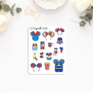 May include: A sticker sheet featuring various Disney-themed illustrations. Designs include Minnie Mouse ears, a backpack, popcorn, and a beverage. The color palette is primarily blue, red, and gold, with the text "LITTLE spark DESIGN" at the top.