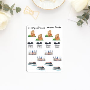 May include: A sheet of stickers featuring various Disney park icons, including the Haunted Mansion, Spaceship Earth, Cinderella's Castle, and the Hollywood Studios logo. The stickers are printed on white paper with a glossy finish.