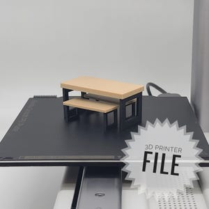 Puede incluir: Un juego de mesa y banco en miniatura con tableros beige y marcos negros. El conjunto se muestra sobre una superficie negra. La imagen incluye un gráfico de estrella blanca con el texto "3D PRINTER FILE".
