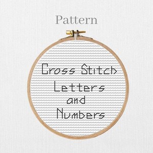 May include: A cross-stitch design in a wooden embroidery hoop. The pattern reads "Cross Stitch Letters and Numbers" in a blocky font. The background is a light grey fabric with a subtle striped texture. The word "Pattern" is at the top.