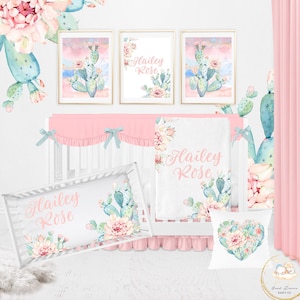 May include: A pink and green cactus themed nursery set with a cot, blanket, pillow, and wall art. The set features the name "Hailey Rose" in a cursive font.