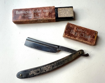 May include: An antique straight razor with a dark blade and a handle engraved with "GEORGE WOSTENHOLM & SONS DOUBLY CARBONIZED REGISTERED SEP.10. 1850." Two vintage boxes are also present, one labeled "Huntington Barber Supply" and the other "Miller's Big Chief."