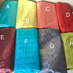 May include: Eight different fabric swatches, labeled A through H. The swatches are folded and arranged in two rows of four. The fabrics are a variety of colors and patterns, including turquoise, yellow, coral, red, maroon, teal, gray, and green.
