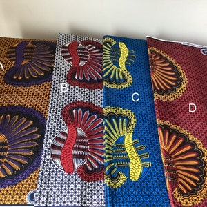 May include: Four colorful fabric samples with bold, repeating patterns. The fabrics feature large, stylized feather or fan-like designs in various color combinations, including orange, purple, red, blue, and yellow. The fabrics are labeled A, B, C, and D.