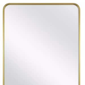 May include: Rectangular mirror with rounded corners, featuring a gold-colored metal frame. The mirror's reflective surface is clear, and the frame has a smooth finish. This decorative mirror is suitable for various home decor styles.
