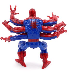 May include: A Spider-Man action figure with multiple arms. The figure is primarily blue and red, with a red spider emblem on the back. The arms are outstretched, and the figure is posed against a white background.