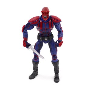 May include: A Red Skull action figure, standing upright and holding a silver sword. The figure is primarily blue and red, with a detailed design. It has a red skull-shaped head and is wearing a black belt and boots. The figure is a collectible item.