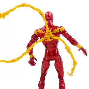 May include: A red and yellow action figure with articulated limbs and a pair of yellow, web-like appendages attached to the back.