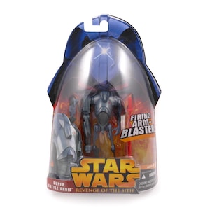 May include: A Star Wars Super Battle Droid action figure in its original packaging. The figure is gray and black, with a blaster. The packaging includes the Star Wars logo and the text "Revenge of the Sith."