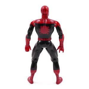 May include: A red and black action figure of a superhero, viewed from the back. The figure has a red head and hands, with a black body and legs. A red spider emblem is on the back. The figure is standing on a white surface.