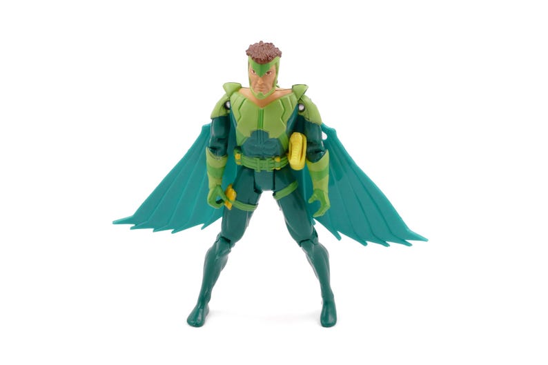 May include: A green and teal action figure of a superhero with a brown hairstyle and teal wings. The figure is wearing a green and teal suit with a yellow belt and accessories. The figure is posed with legs spread and arms at its sides.