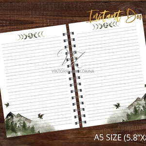 May include: A white notebook with a black spiral binding. The front and back covers feature a watercolour illustration of a mountain range with trees and birds. The top of the notebook has a decorative design of crescent moons. The text "A5 SIZE (5.8"x8.3")" is printed at the bottom of the notebook.