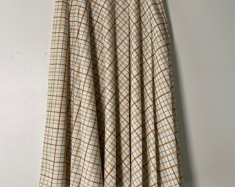 May include: A white skirt with a brown and blue plaid pattern. The skirt is knee-length and has a flared silhouette.