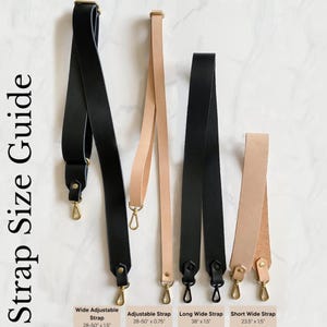 Op de afbeelding: Riemenmaatgids met vier leren riemen en metalen hardware. Bevat een brede verstelbare riem zwart 28-50 x 1,5 inch, een verstelbare riem beige 28-50 x 0,75 inch, een lange brede riem zwart 38 x 1,5 inch en een korte brede riem beige 23,5 x 1,5 inch.