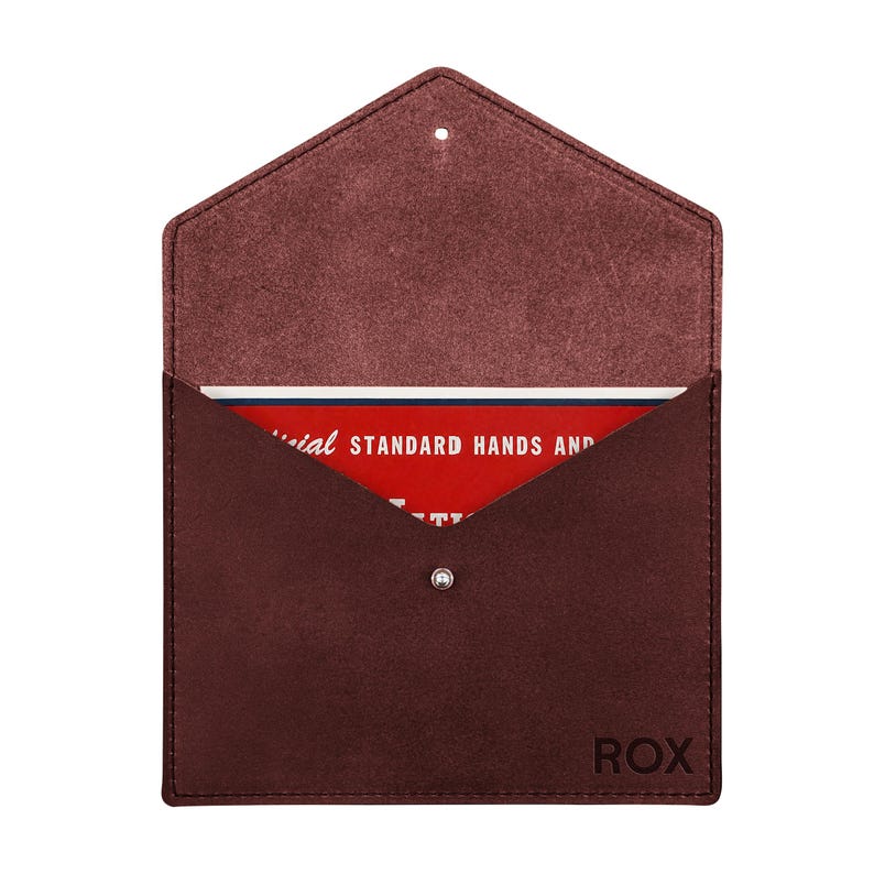 May include: A dark maroon suede envelope-style pouch with a pointed flap and a silver snap closure. The word ROX is embossed in the bottom right corner. Inside, a red card is visible with white text reading STANDARD HANDS AND.