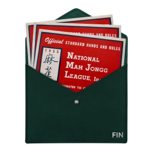 May include: A dark green envelope-style case with a silver snap closure and the word FIN printed in the corner. Inside are several red cards titled Official Standard Hands and Rules National Mah Jongg League, Inc. 1955 with Chinese characters.