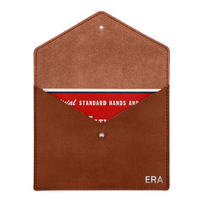 May include: A brown leather envelope-style pouch with a pointed flap and a silver snap closure. The bottom right corner features the embossed text ERA. Inside, a red card is visible with white text reading Official Standard Hands and.