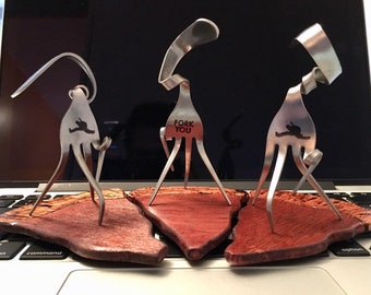 The Fork You Sculpture with wood pizza slice stand