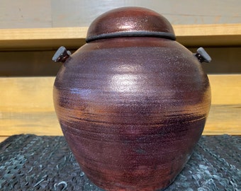 Covered copper Raku pottery jar with bow ties