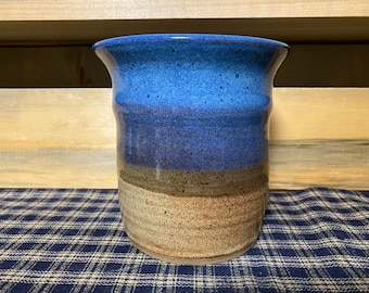 Floating blue and light rust pottery utensil holder