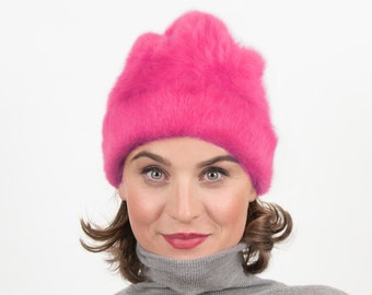 Cozy winter beanie made from angora in intense pink. The warm hat creates an elegant look on frosty winter days. Lil