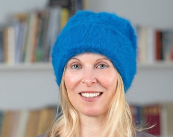 Cosy winter beanie made of angora in the colour water blue. The warm designer beanie provides a cool look on frosty winter days. Lil