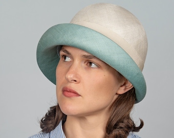 A two-tone summer cloche crafted from the finest straw. Elegant, feminine – an exclusive, one-of-a-kind piece with timeless appeal, Aimée