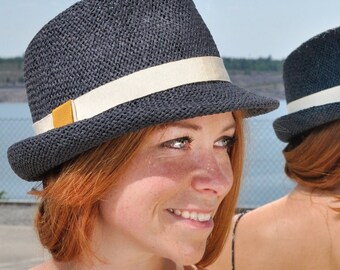 Summery,lightweight trilby made of braided paper yarn, with small symmetrical hat brim in elegant design and color accented hatband.Marcello
